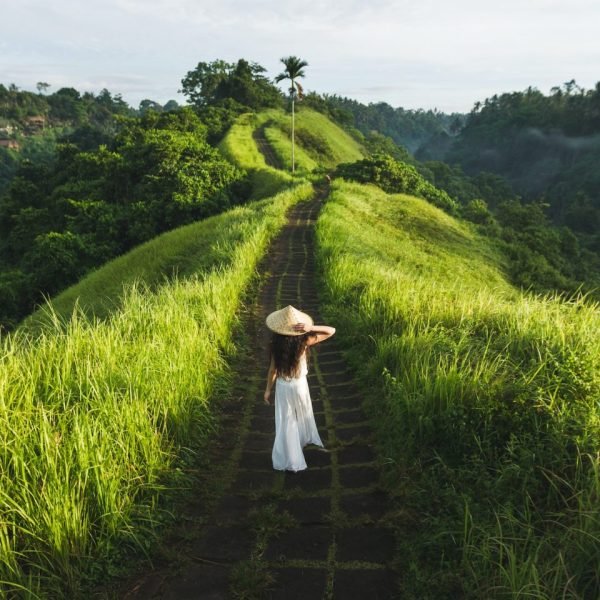 young-beautiful-woman-walking-on-campuhan-ridge-way-of-artists-in-bali-ubud--e1687499737698